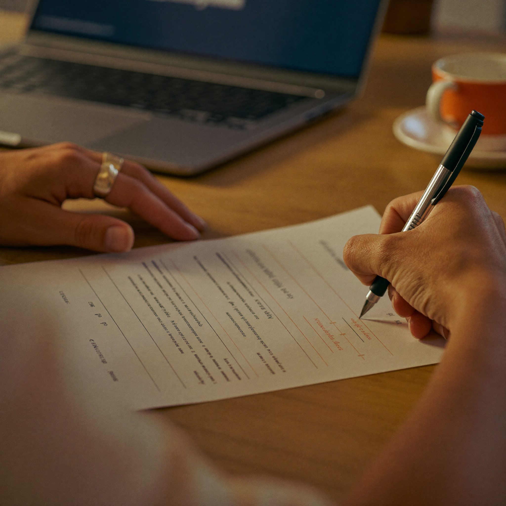 Close-up of a client reviewing and signing a tax document